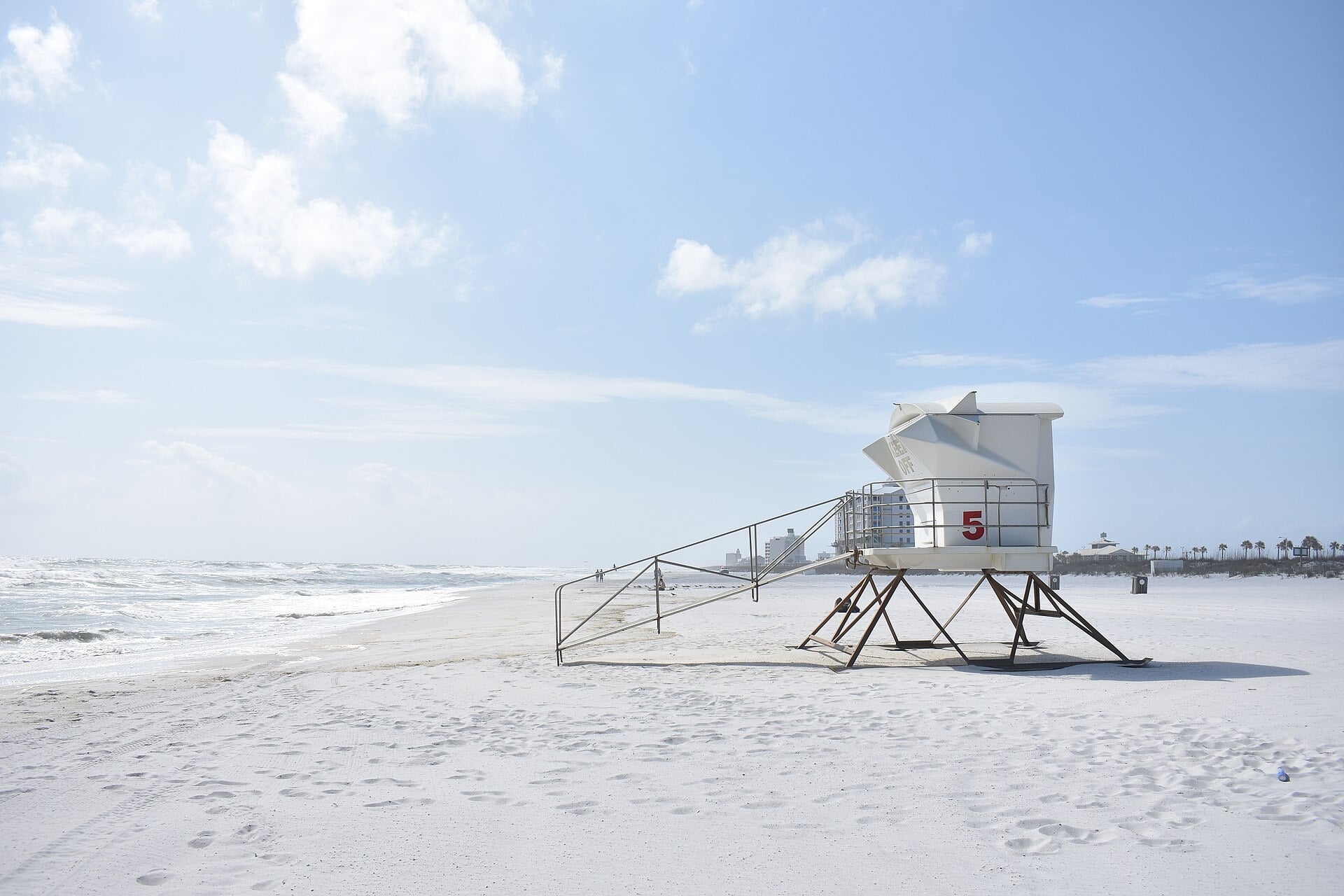 A white lifeguard tower on the sugar-white sand of Pensacola Beach