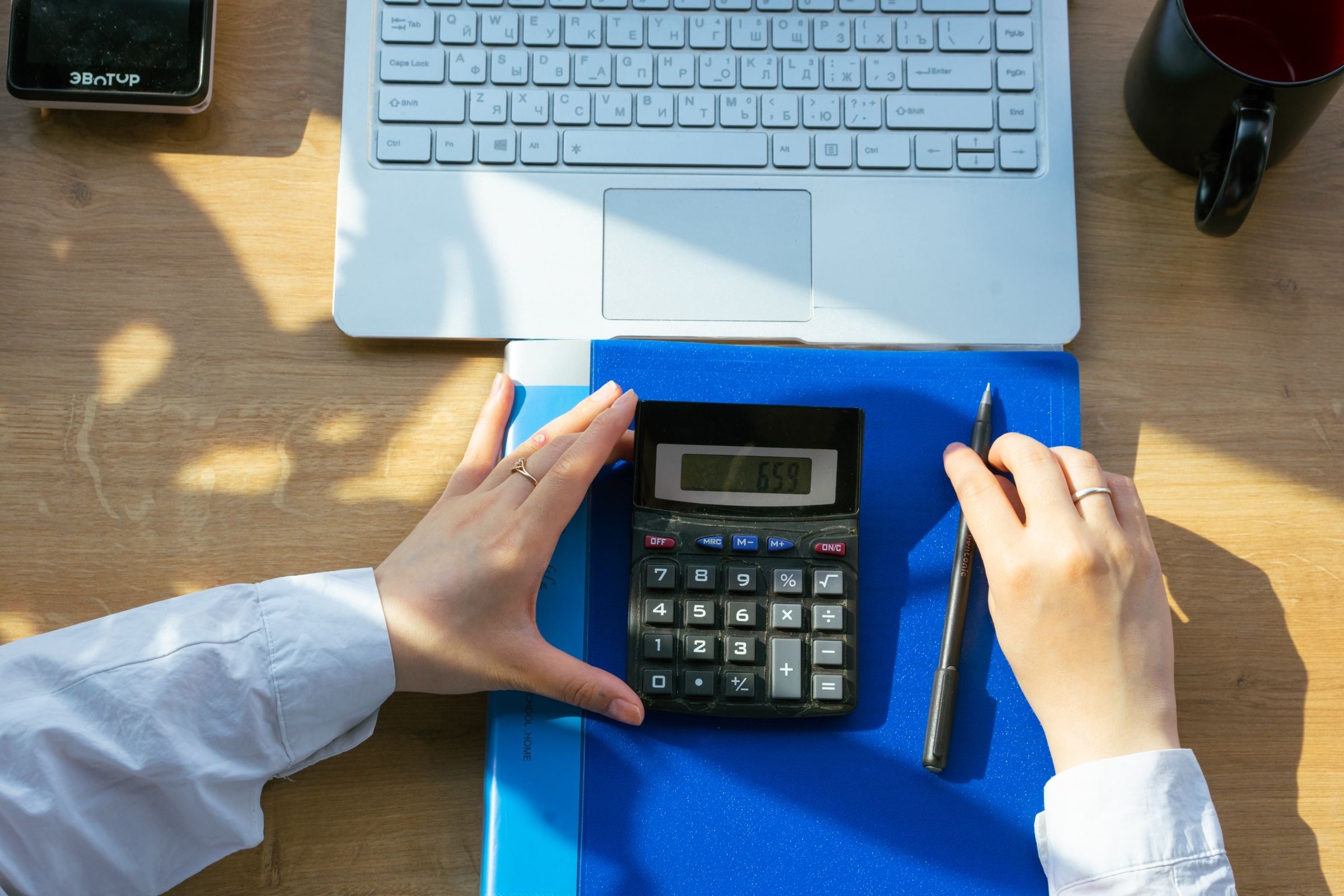 Un contador revisa recibos con lápiz y calculadora