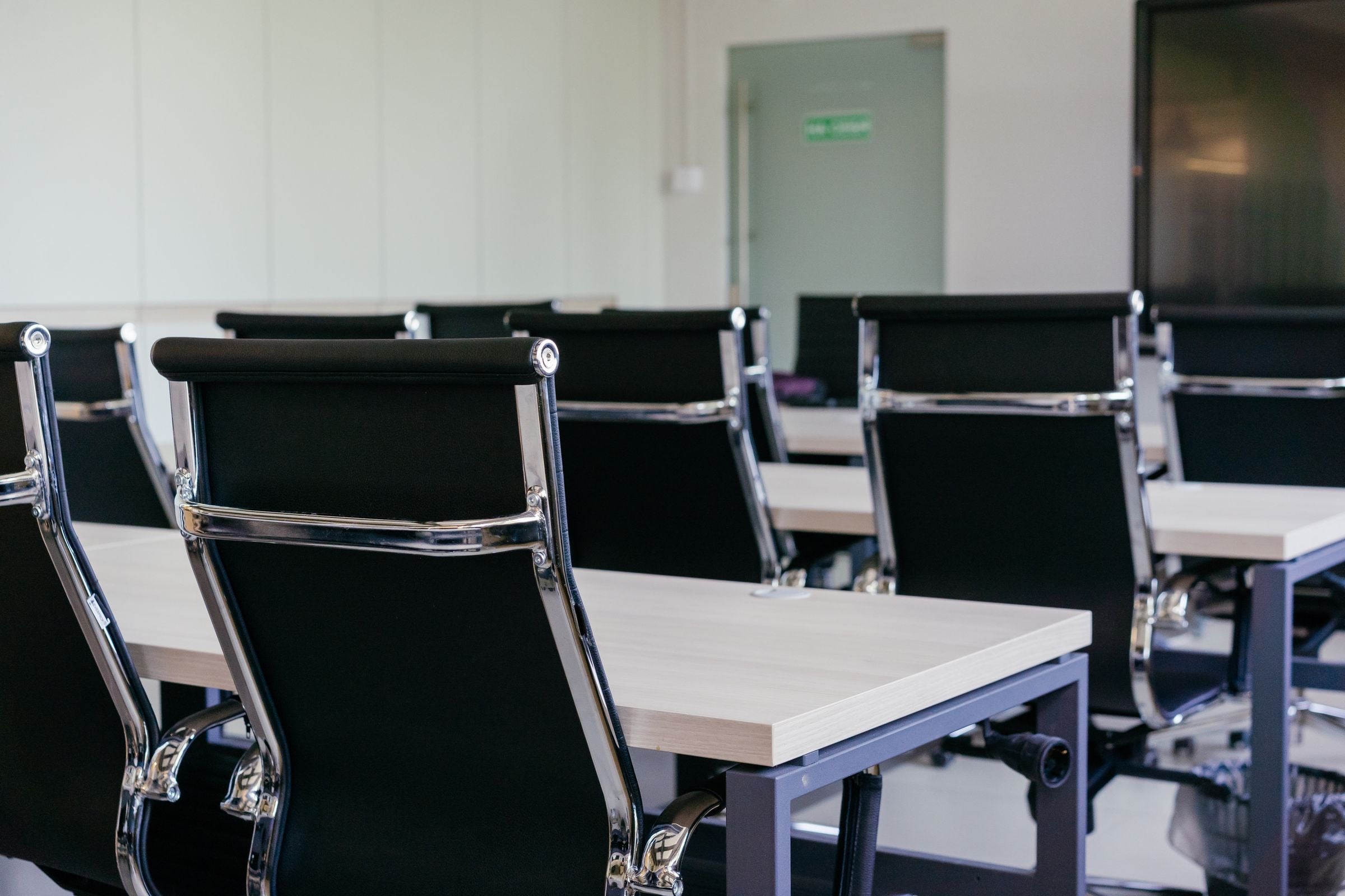 A bright conference room with a long table set for a meeting