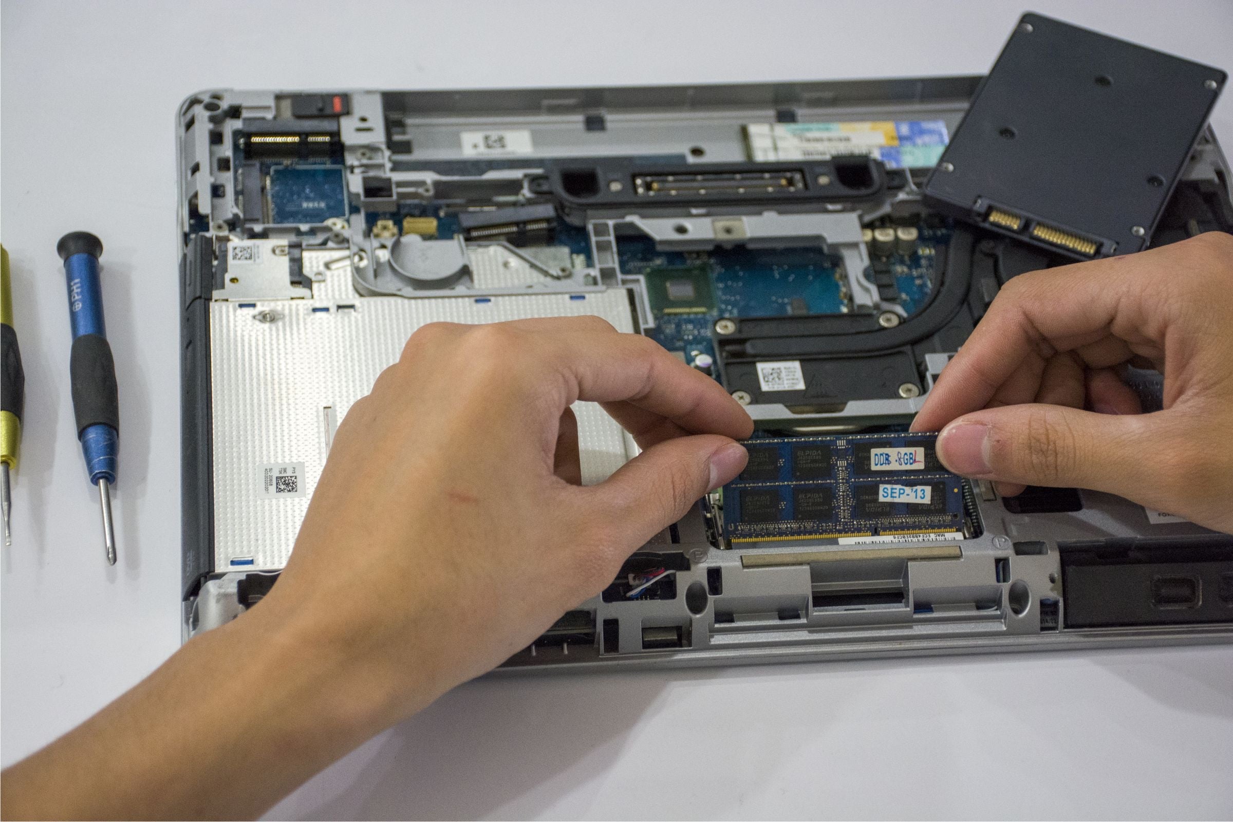 A technician working inside a desktop computer